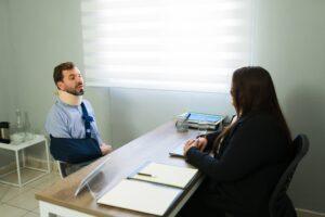 Female lawyer consults with man with traumatic brain injury. Find out how much the average traumatic brain injury settlement is worth.