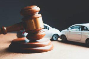 A car accident lawyer writing at their desk. Find out how to find the best car accident lawyer.