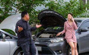 Damaged cars sitting in the middle of the road. Find out whose insurance pays in a multi-car accident in VA.